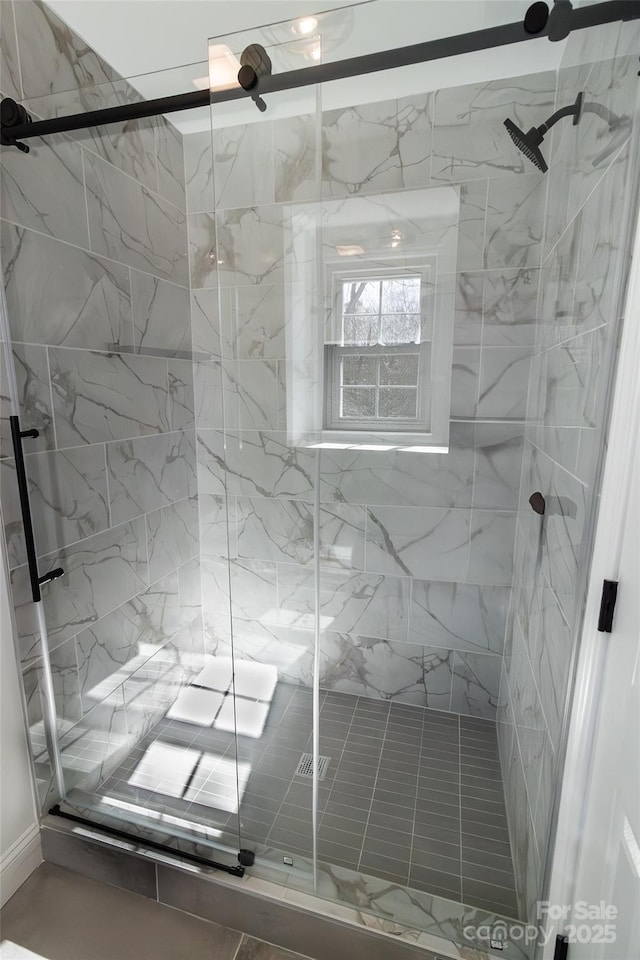 full bath with a marble finish shower