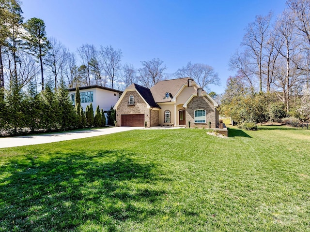 view of front of property with driveway, stone siding, an attached garage, and a front yard