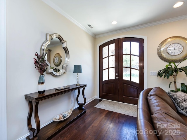 entryway with dark wood-style flooring, visible vents, baseboards, ornamental molding, and french doors