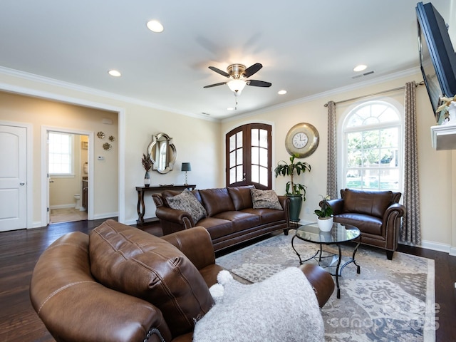 living area featuring dark wood-style floors, visible vents, crown molding, and baseboards