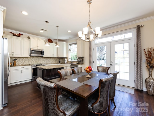 dining room featuring french doors, recessed lighting, ornamental molding, dark wood-type flooring, and a chandelier