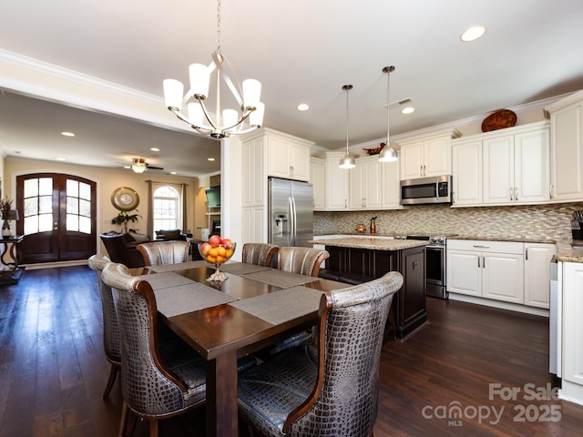 dining space featuring french doors, recessed lighting, dark wood finished floors, and crown molding