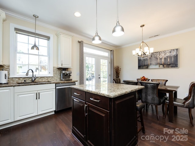 kitchen with white cabinets, dishwasher, ornamental molding, dark wood-style flooring, and a sink