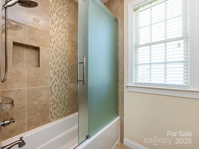 full bathroom with bath / shower combo with glass door