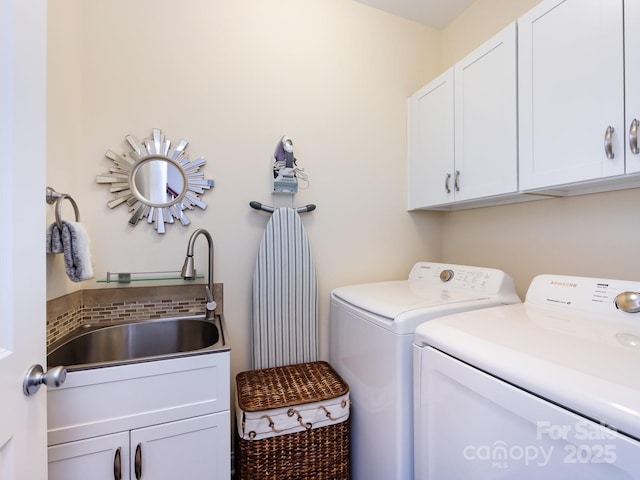 laundry area with a sink, cabinet space, and washer and dryer