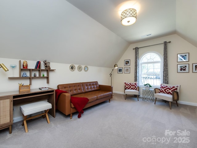 interior space with baseboards, visible vents, vaulted ceiling, and carpet flooring