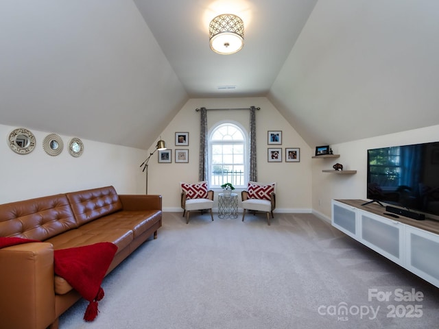 carpeted living room featuring lofted ceiling, visible vents, and baseboards