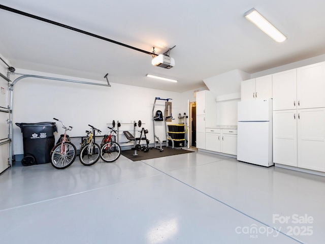 garage with a garage door opener and freestanding refrigerator