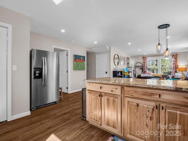 kitchen featuring dark wood-style flooring, recessed lighting, open floor plan, light stone countertops, and stainless steel fridge