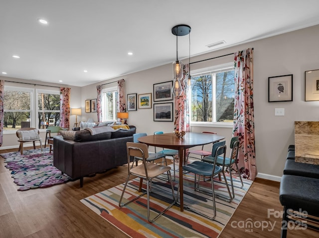 dining room featuring visible vents, baseboards, wood finished floors, and recessed lighting