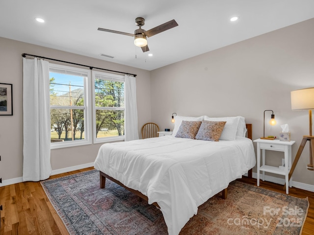 bedroom with recessed lighting, baseboards, and wood finished floors