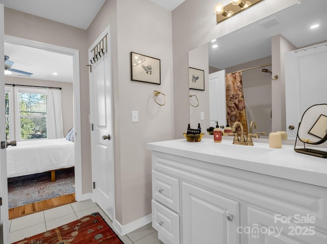 ensuite bathroom with ensuite bathroom, tile patterned flooring, vanity, visible vents, and a ceiling fan