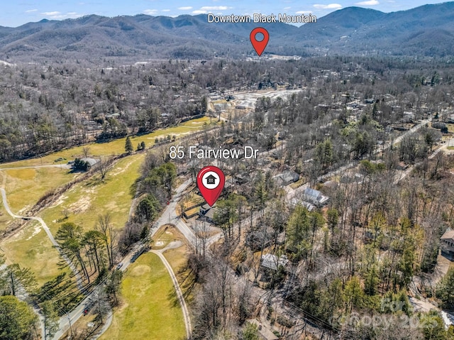 birds eye view of property with a mountain view and a forest view