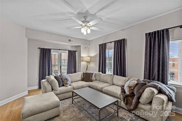 living room with a healthy amount of sunlight, light wood-style flooring, and visible vents