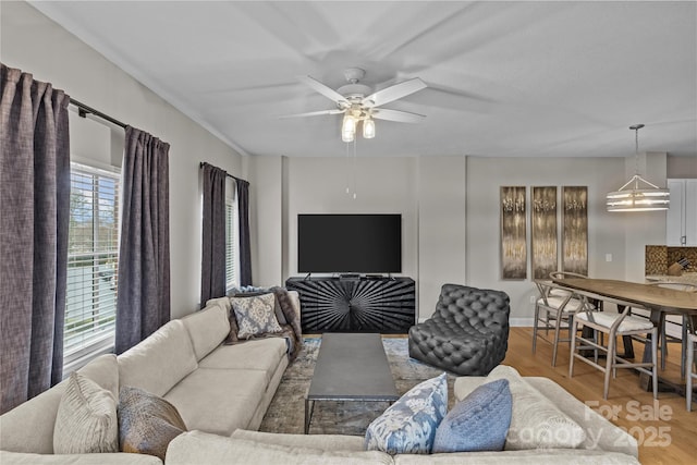 living area featuring ceiling fan and wood finished floors