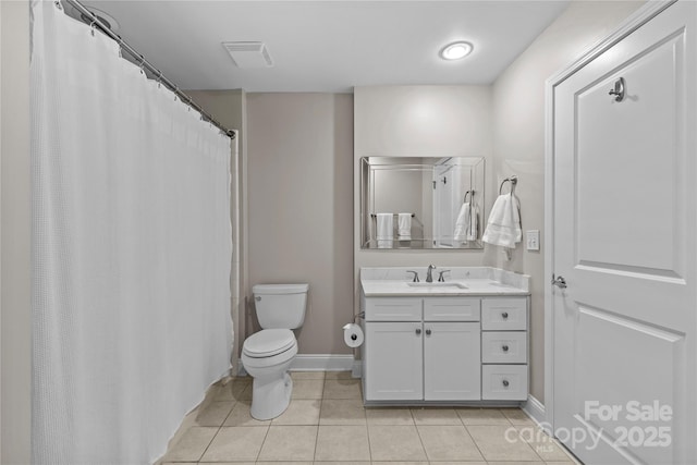 bathroom with visible vents, toilet, vanity, baseboards, and tile patterned floors