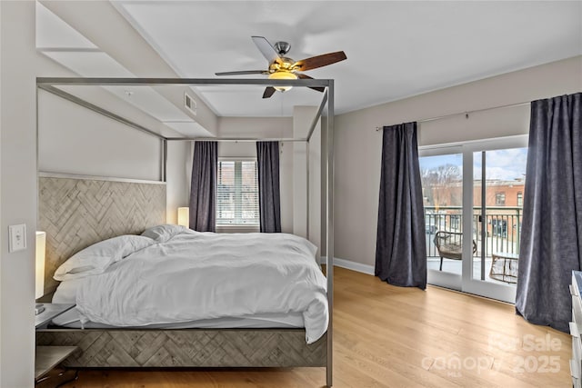 bedroom with visible vents, light wood-style flooring, a ceiling fan, access to outside, and baseboards