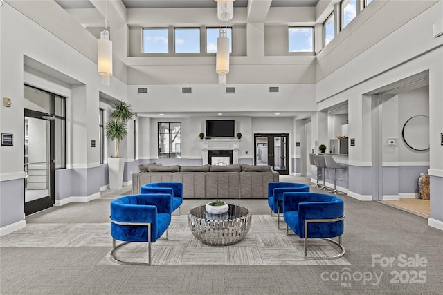 living area featuring light carpet, french doors, a fireplace, and visible vents