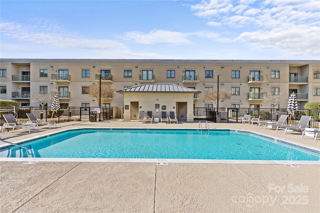 pool featuring fence and a patio