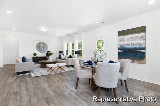 dining space with recessed lighting, baseboards, and wood finished floors