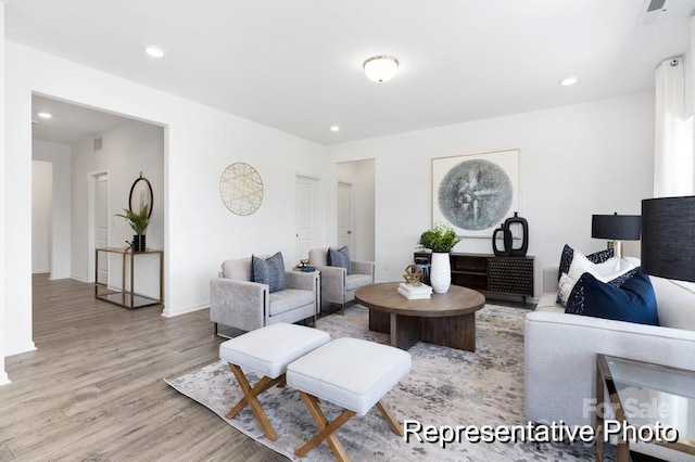 living room featuring recessed lighting, visible vents, light wood-style flooring, and baseboards