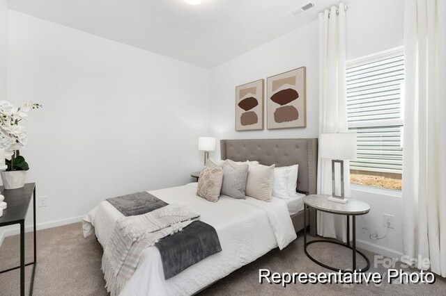 bedroom featuring carpet floors, visible vents, and baseboards