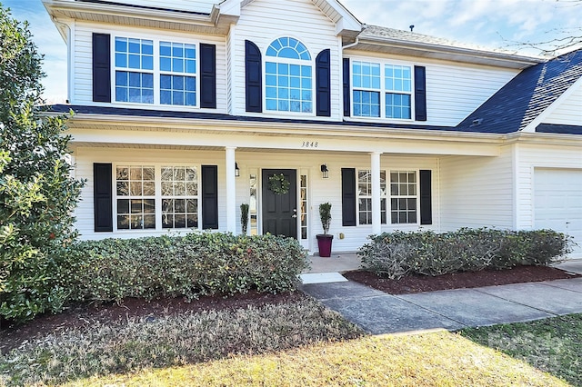 view of front of property with an attached garage and a porch