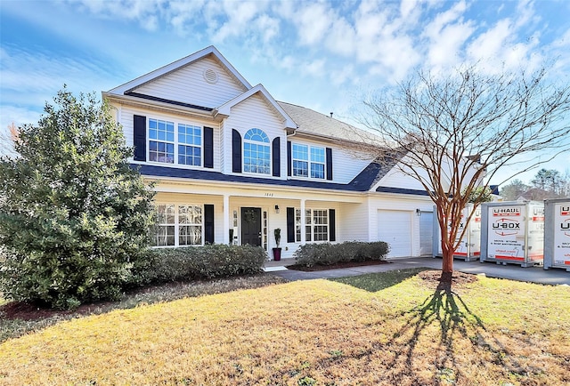 view of front of home with a front yard, driveway, and an attached garage