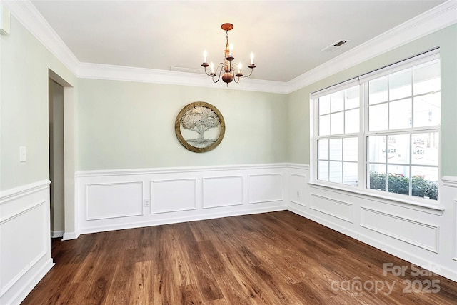 unfurnished dining area with dark wood-style floors, visible vents, a notable chandelier, and ornamental molding