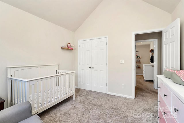 bedroom featuring light carpet, a crib, baseboards, high vaulted ceiling, and a closet