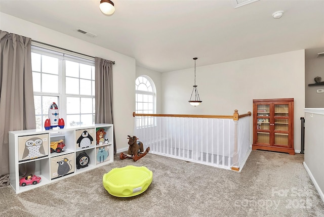 playroom featuring carpet, visible vents, and baseboards