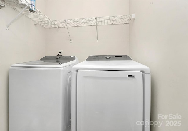 clothes washing area featuring laundry area and separate washer and dryer