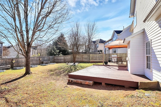 view of yard featuring a residential view, a fenced backyard, and a wooden deck