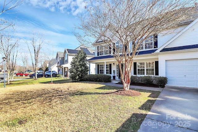 traditional-style house featuring an attached garage, driveway, and a front lawn