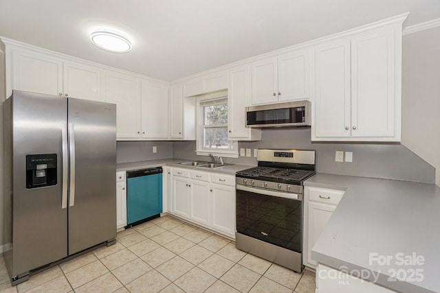 kitchen featuring stainless steel appliances, white cabinets, and a sink