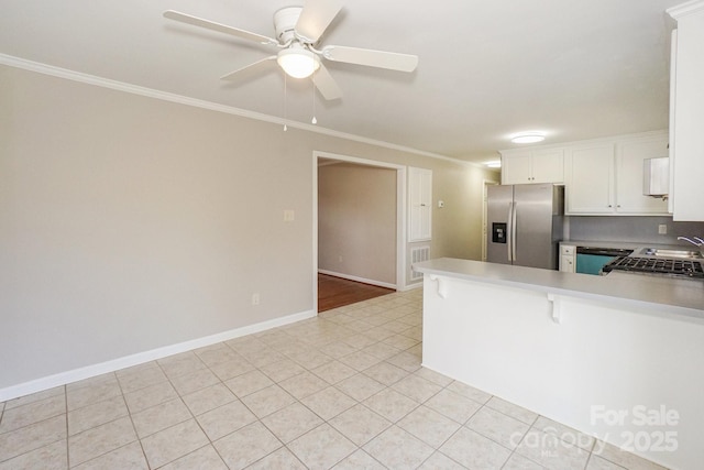 kitchen featuring a peninsula, a ceiling fan, white cabinets, ornamental molding, and stainless steel fridge with ice dispenser