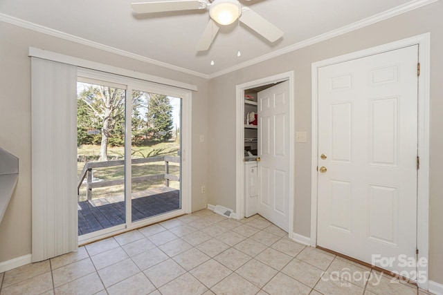 entryway featuring light tile patterned floors, ornamental molding, a ceiling fan, and baseboards