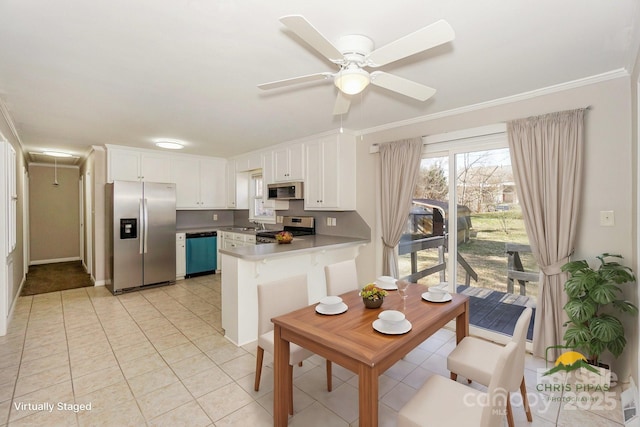 kitchen featuring light tile patterned floors, appliances with stainless steel finishes, ornamental molding, white cabinetry, and a peninsula