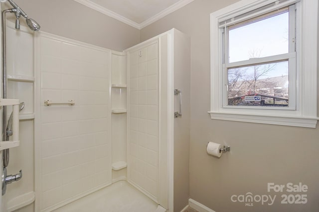 bathroom with ornamental molding and walk in shower