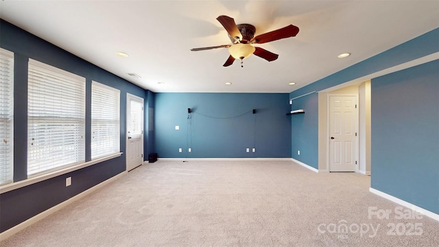 spare room featuring recessed lighting, light colored carpet, ceiling fan, and baseboards