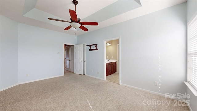 spare room with plenty of natural light, baseboards, ceiling fan, and light colored carpet