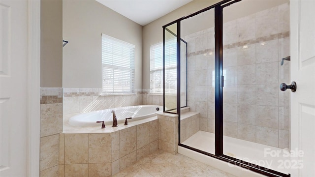 bathroom with tile patterned flooring, a shower stall, and a bath