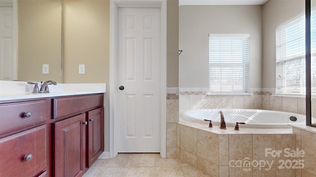 bathroom featuring a garden tub, tile patterned floors, and vanity