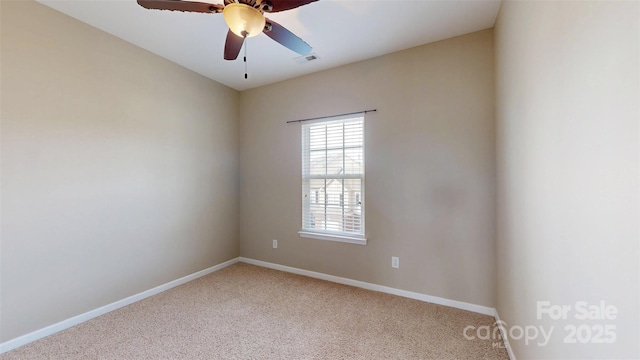 unfurnished room featuring light colored carpet, visible vents, ceiling fan, and baseboards