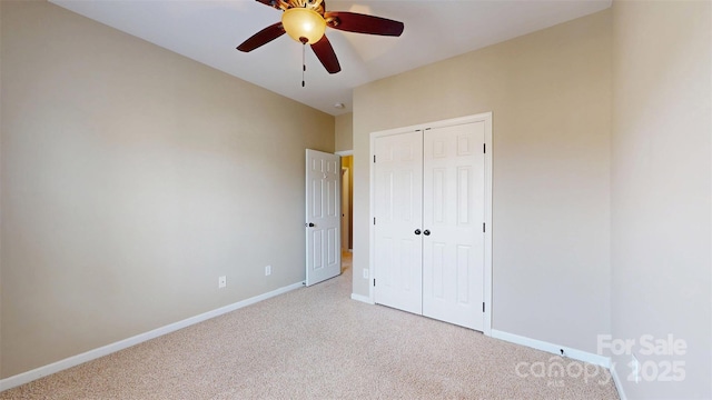 unfurnished bedroom with a ceiling fan, baseboards, a closet, and light colored carpet