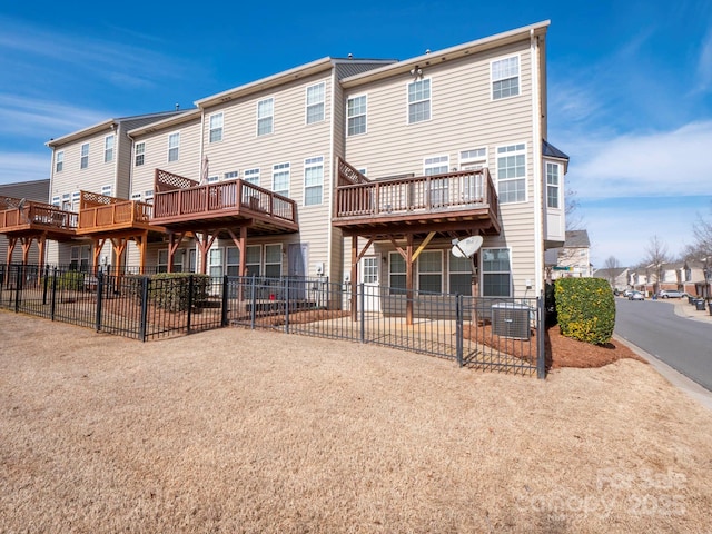 back of house with fence and a residential view