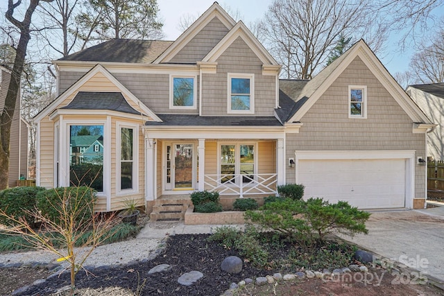 view of front of property with a porch, concrete driveway, and an attached garage