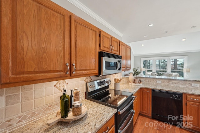 kitchen featuring light stone counters, ornamental molding, appliances with stainless steel finishes, decorative backsplash, and brown cabinetry