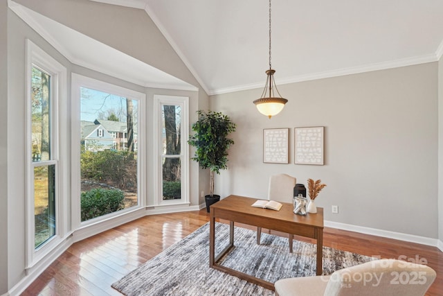 office area with baseboards, ornamental molding, vaulted ceiling, and hardwood / wood-style floors