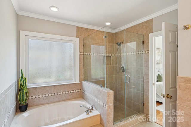 ensuite bathroom with ornamental molding, a shower stall, a bath, and a healthy amount of sunlight